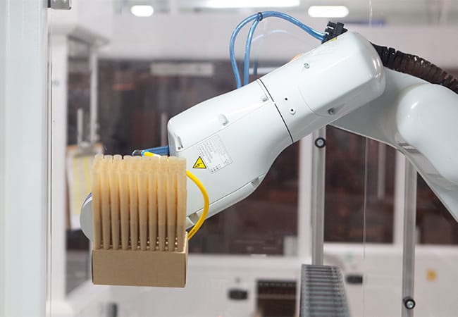 a robot arm holding a box of cones